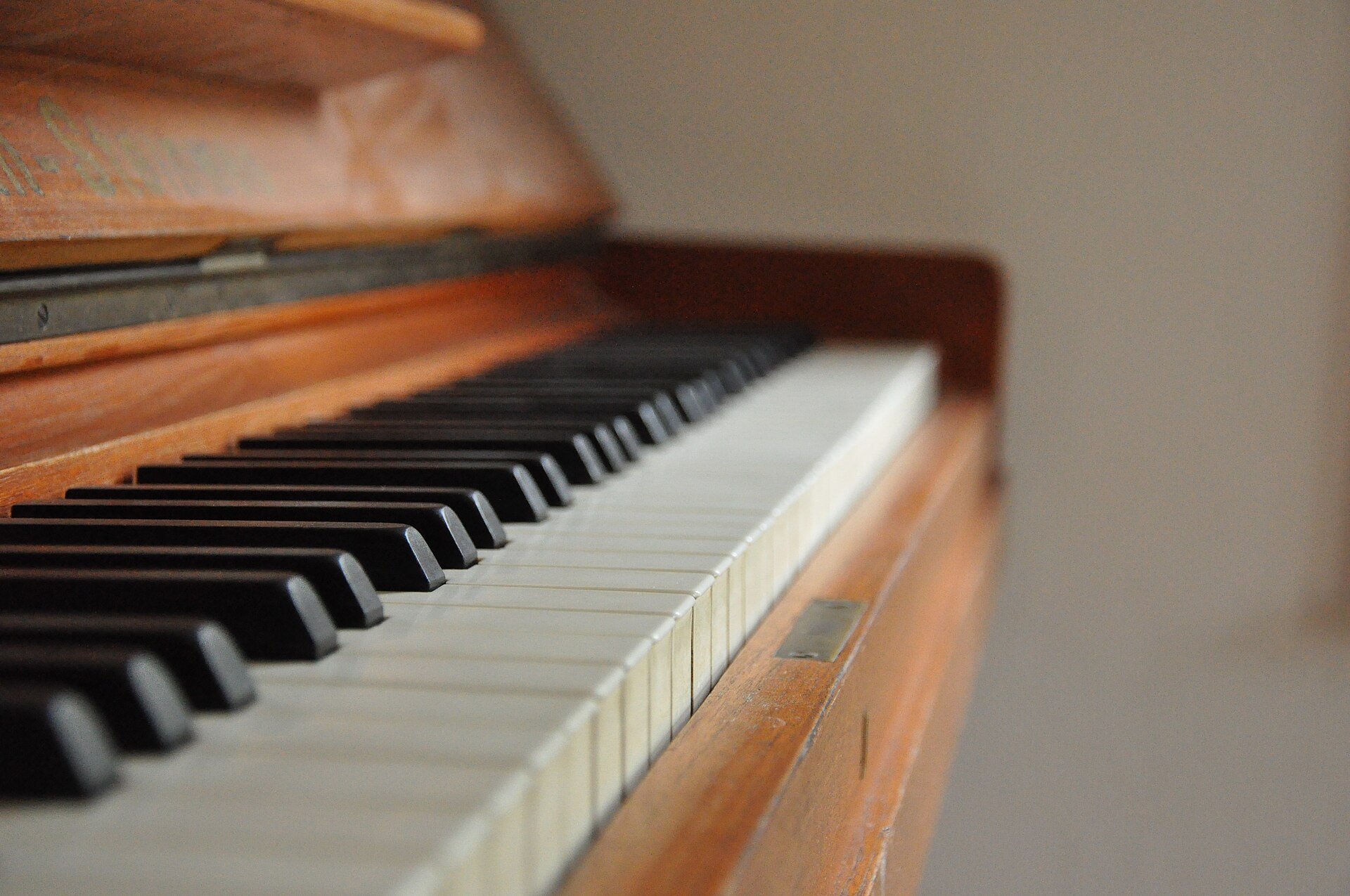 Touches noires et blanches d'un piano droit en bois vues de près